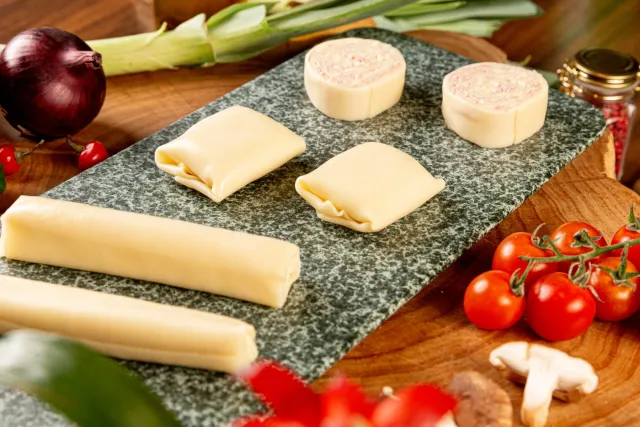 Rondelli, canelone e sofioli crus sobre pedra, com tomates e cogumelos